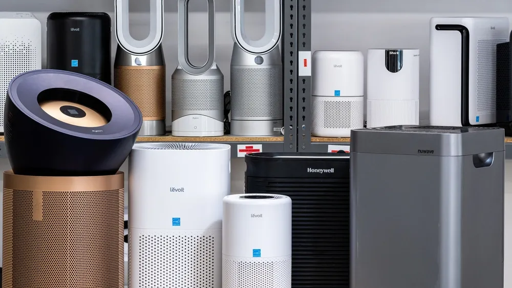 A collection of the 4 best air purifiers of 2025 displayed on shelves with various brands and designs.