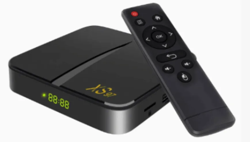Black IPTV TV box with LED display and a remote control featuring navigation and media buttons.