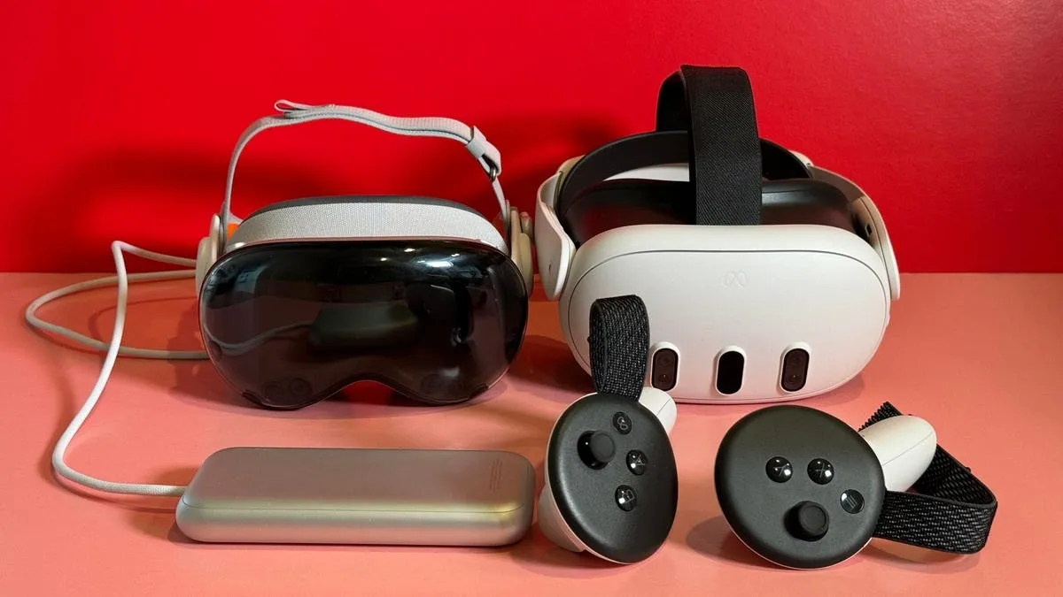 Meta Quest 3 and Apple Vision Pro VR headsets with their controllers displayed side by side on a red surface.